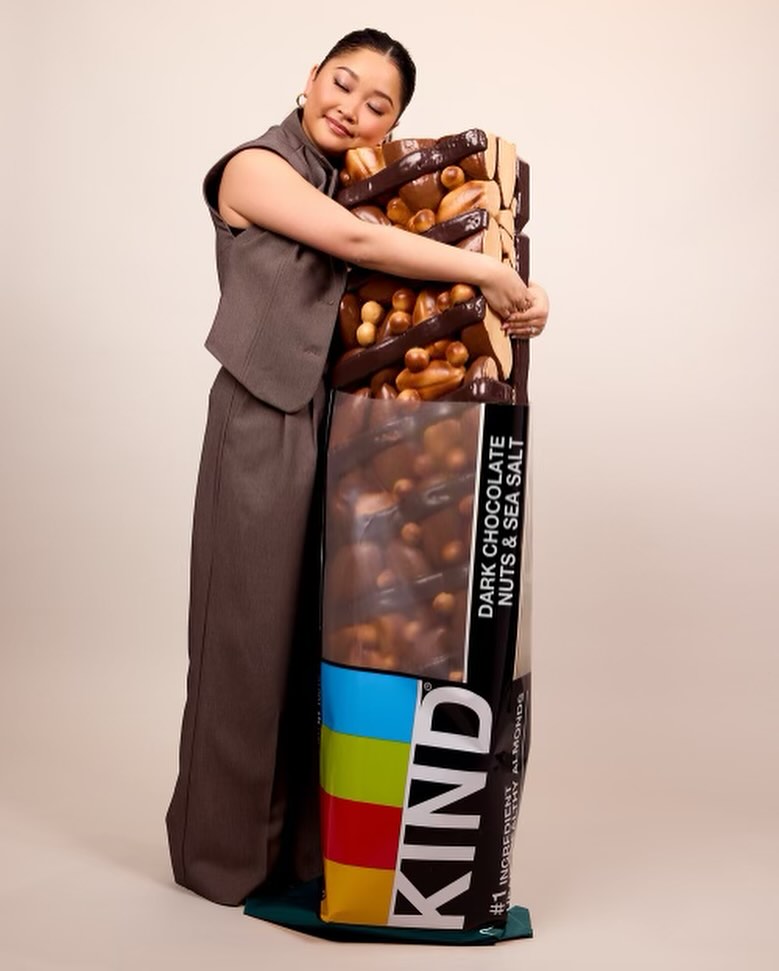 Lana Condor hugging oversized KIND bar