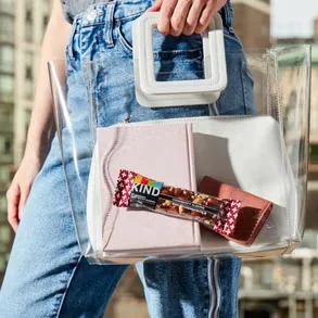 Previous KIND visual identity — lifestyle handbag scene
